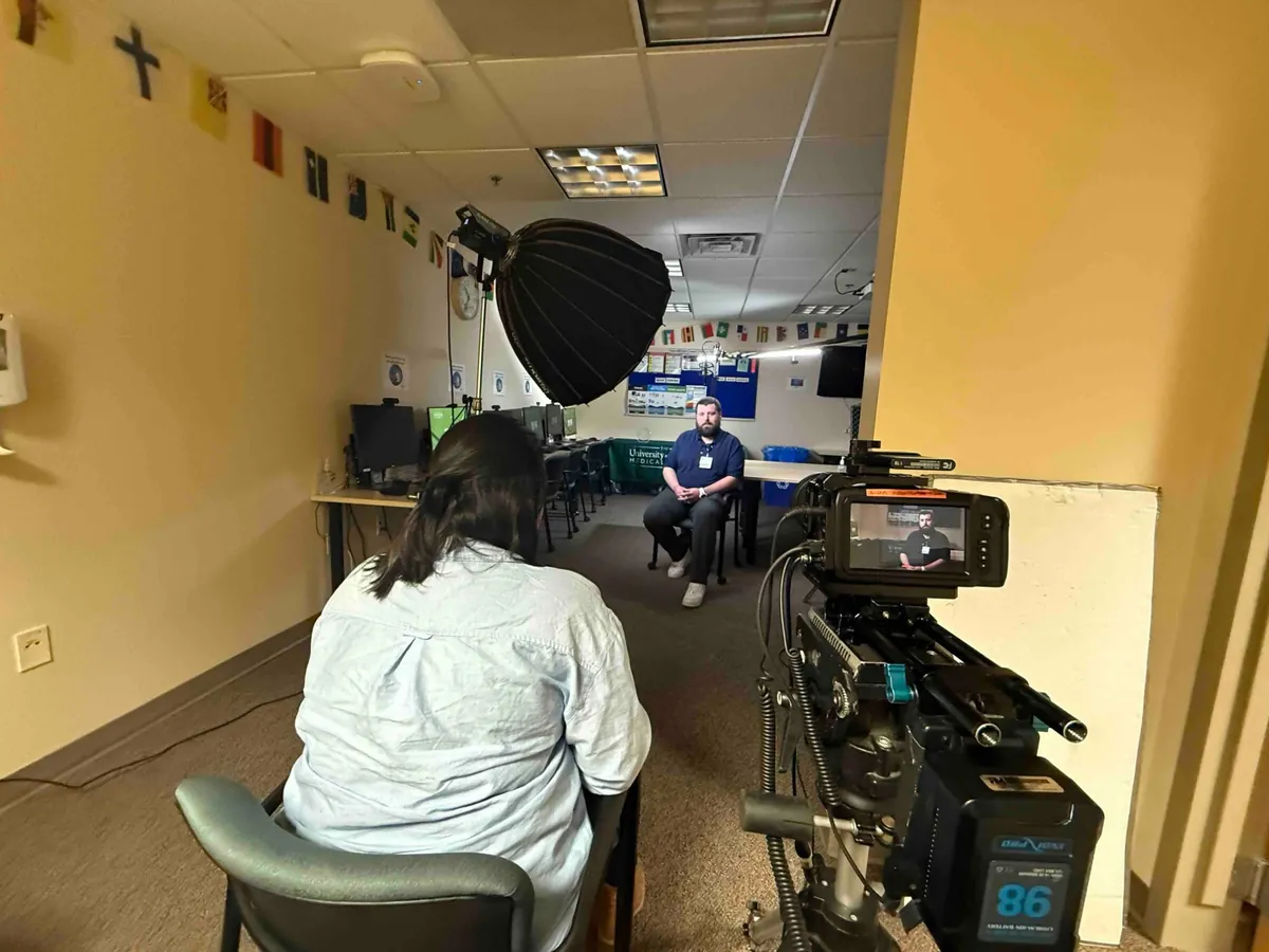 An interview set up in a hospital corridor hung with international flags.